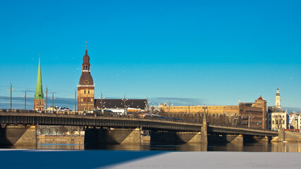 Fototapeta na wymiar riga. in the photo, a panorama of the city and a stone bridge against the blue sky