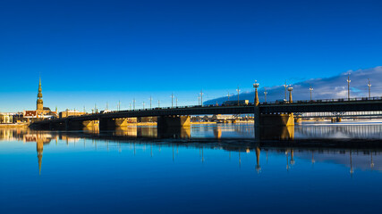 riga. in the photo, the stone bridge, in the background, the city against the blue sky