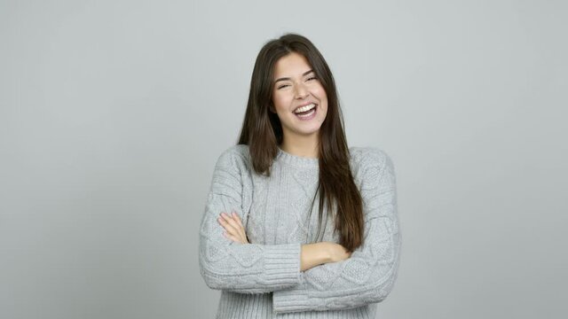 Teenager Brazilian girl smiling a lot while covering mouth over isolated background