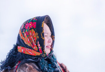 Young girl, in the national winter clothes of the northern inhabitants of the tundra, the Arctic circle, ethnic Nenets