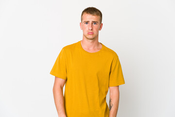 Obraz premium Young caucasian handsome man blows cheeks, has tired expression. Facial expression concept.