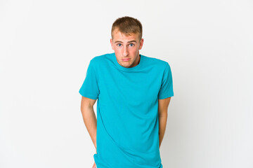Obraz premium Young caucasian handsome man shrugs shoulders and open eyes confused.