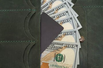 leather wallet with dollars inside.