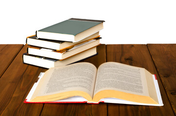 books lie on a wood table. isolated books