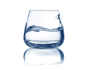 glass of drinking water with wave surface level isolated on white background 