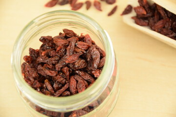 Dried goji berries on jar,  wooden background, super food, organic healthy food