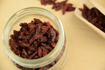 Dried goji berries on jar,  wooden background, super food, organic healthy fruits