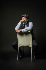 in a cap on a chair Young male three piece suit fashion, attractive casual clothing. Men city, success smile background black bodybuilder