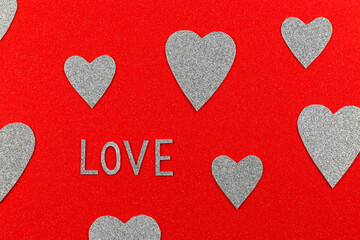 Love Text And Silver Hearts On Red Design