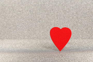 Obraz premium Vibrant Red Heart Standing On Textured Silver
