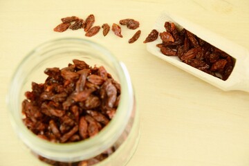 Dried goji berries on jar,  wooden background, super food, organic super fruits