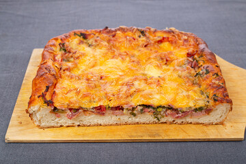 Cutting board with a piece of meat pie on the table