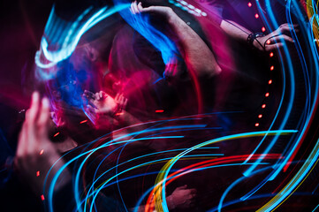 Closeup view of the colorful blurred lights with the motion of people dancing in the club