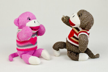 A sock monkey proposing marriage to his love
