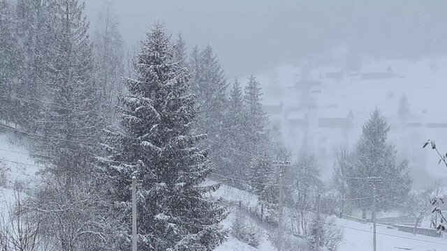 Slavske, Ukraine. View of the ski resort Slavske in Ukraine in winter. Snowfall in the mountains. Houses in the background.