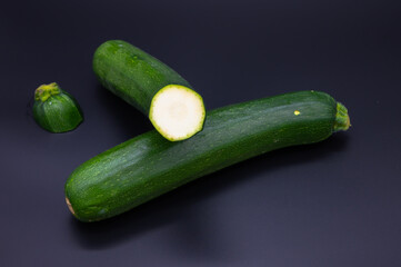 colorful bio fresh green zucchini on black background