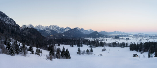 Beautiful winter panorama of Neuschwanstein and Hohenschwangau castle at sunrise