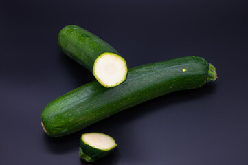 colorful bio fresh green zucchini on black background