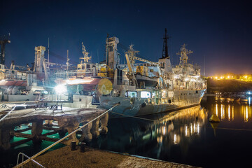 Cargo ship and cranes at night in port of Sevastopol, Crimea