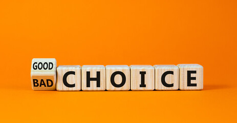 Good or bad choice symbol. Turned a wooden cube and changed words 'bad choice' to 'good choice'. Beautiful orange background, copy space. Business and good choice concept.