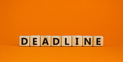 Deadline symbol. Concept word 'deadline' on wooden cubes on a beautiful orange background. Business and deadline concept.
