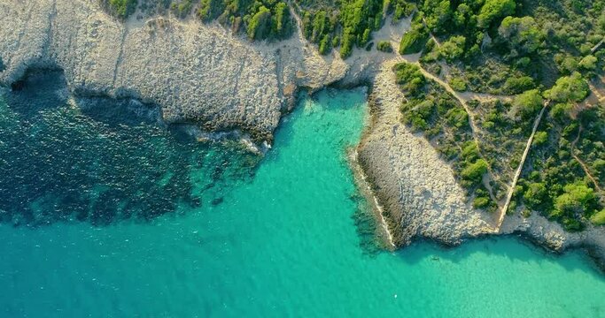 Cove in Menorca with turquoise ans transparent water next to a forest on the island  4K