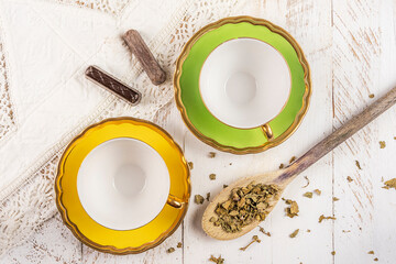 two empty yellow teacup on white wooden background