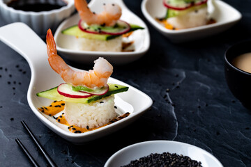 Small dishes of homemade deconstructed sushi ready for eating.