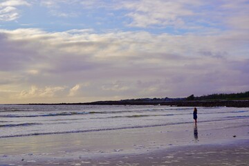 Fototapeta na wymiar Lone figure on a Connemara beach