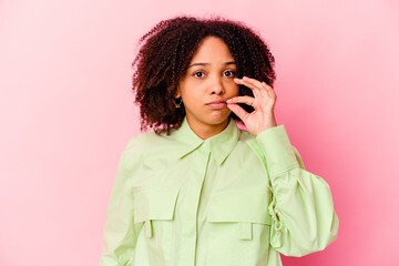 Young african american mixed race woman isolated with fingers on lips keeping a secret.