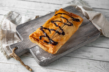 Puff pastry bun stuffed with apples, berries, or cottage cheese and potatoes, mini pie. Bakery products. Sweet pastry.