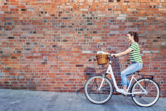 Woman riding on the background of a brick wall, Poland, &asymp;&otilde;l&fnof;&Ouml;skie, Katowice
