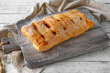 Puff pastry bun stuffed with apples, berries, or cottage cheese and potatoes, mini pie. Bakery products. Sweet pastry.