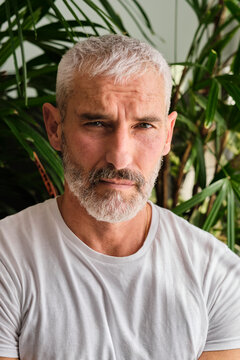 Handsome Mature Man With White Hair And Beard At Home