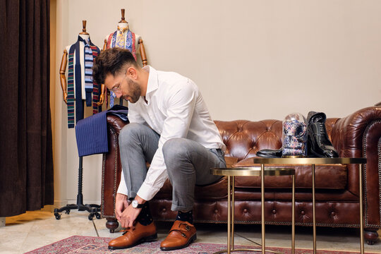 Man fastening monk shoe in tailors boutique