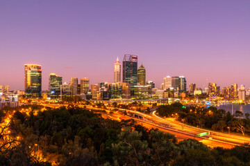 Australia,¬†Western Australia, Perth, Kings Park and Mounts Bay Road at dusk with city skyline in background