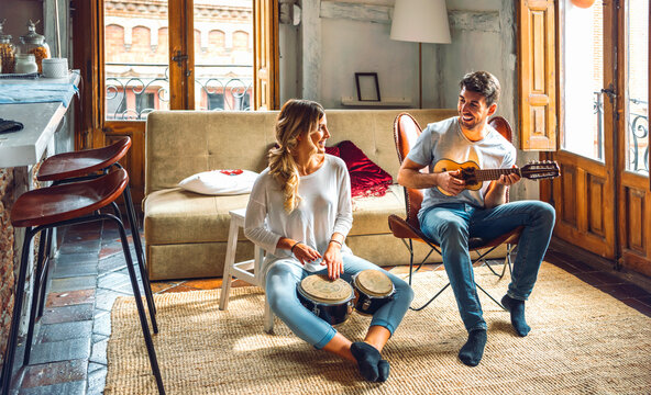 Happy couple playing musical instruments
