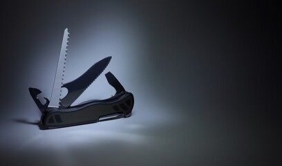 Folding pocket knife Multi-Tool on a black background - obrazy, fototapety, plakaty