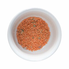 red lentils in bow isolated over white