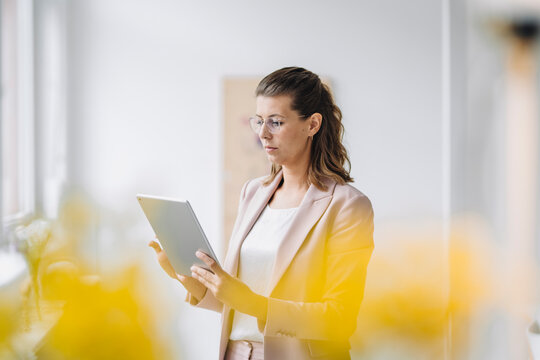 Businesswoman using digital tablet in office