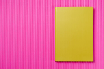 Green Leather notebook on paper pink background, notepad mock up, top view shot