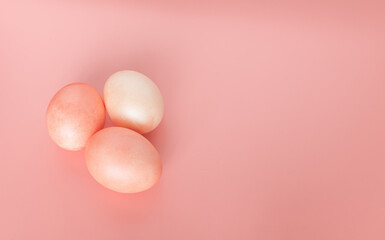 Easter eggs on a light, delicate pink background. Space for text, top view