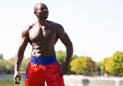Sportsman contemplating while standing in park on sunny day