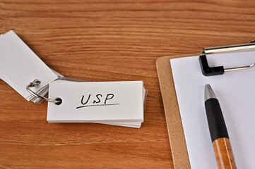 On the desk there is a laptop, a clipboard, and a word book with the word USP written on it. It was...