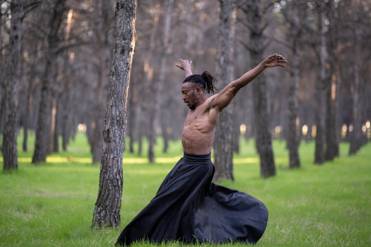 Professional dancer performing alone in middle of forest