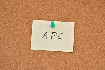A piece of paper labeled APC is pinned to the corkboard.