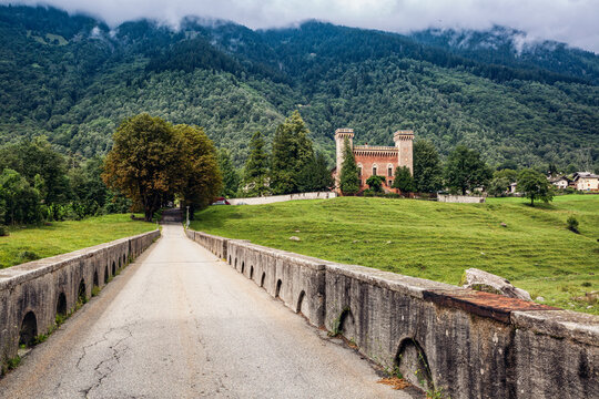 Switzerland, Canton of Grisons, Coltura, Old stone bridge with Castelmur Castle in background