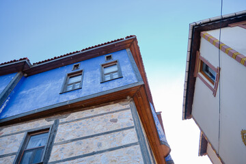 Old ottoman style house with blue color and narrow street with sunshine Golyazi. Uluabat lake. Bursa. Turkey.