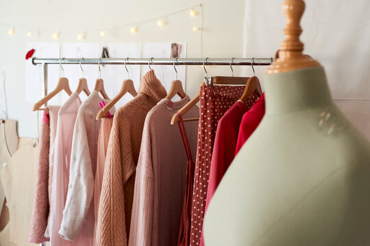 Dressmaker's model against clothes rack at design studio