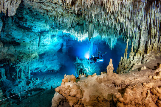 Male diver swimming in underwater, Cenote Uku Cusam, Quintana Roo, Mexico